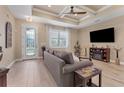 Bright living room with hardwood floors, a comfy sofa, and a fireplace at 191 Brig W Cir, Placida, FL 33946