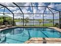 Sparkling pool with screened enclosure and lake view at 20 Mate Cir, Placida, FL 33946