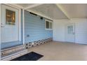 Covered patio with exterior door and access to laundry area at 740 Summersea Ct, Englewood, FL 34223