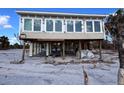 Elevated beach house with storm damage, requiring repairs at 8160 Little Gasparilla Is, Placida, FL 33946