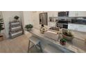 Modern kitchen with stainless steel appliances and granite countertops at 9174 Bensonhurst Ln, Englewood, FL 34224