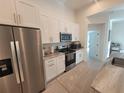 Modern kitchen with stainless steel appliances and granite countertops at 9174 Bensonhurst Ln, Englewood, FL 34224