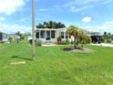 Single-wide home with a screened porch and spacious yard at 6246 Parakeet Rd, Englewood, FL 34224