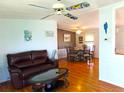 Bright living room with hardwood floors, leather furniture, and decorative accents at 6246 Parakeet Rd, Englewood, FL 34224