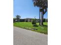 Ranch style home with mature landscaping and a large front yard at 1455 Crest Dr, Englewood, FL 34223