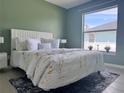 Stylishly furnished bedroom with a large window that allows for natural light at 35 Mark Twain Ln, Rotonda West, FL 33947