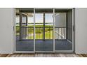 Balcony doors opening to a scenic view of lush greenery and a tranquil bay at 6000 Boca Grande Cswy # D46, Boca Grande, FL 33921