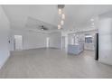 Spacious open layout with light tile flooring, modern lighting, and easy access to the kitchen at 9262 Genesee St, Port Charlotte, FL 33981