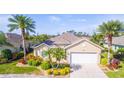 One-story house with two-car garage and landscaping at 417 Tomoka Dr, Englewood, FL 34223