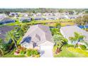 Aerial view of a house with lush landscaping at 417 Tomoka Dr, Englewood, FL 34223