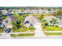 Aerial view of a house with lush landscaping at 417 Tomoka Dr, Englewood, FL 34223