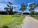 Single-story home with a long driveway and large yard at 2573 Chynn Ave, North Port, FL 34286