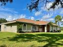 Single-story home with a large yard and mature trees at 2573 Chynn Ave, North Port, FL 34286