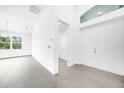 Bright entryway with tile floors and access to laundry at 9309 Zorn St, Port Charlotte, FL 33981