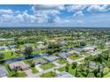 Aerial view of a residential neighborhood with houses and canals at 64 Long Meadow Ln, Rotonda West, FL 33947