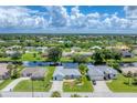 Aerial view of a residential neighborhood with houses and canals at 64 Long Meadow Ln, Rotonda West, FL 33947