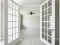 Spacious office with white tile floors and french doors at 5240 Willow Lake Ct, Sarasota, FL 34233