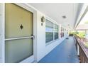 Building hallway with exterior door and windows at 3 Quails Run Blvd # 8, Englewood, FL 34223