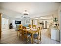 Dining area with table and chairs, open to kitchen and living room at 9273 Carnation Ave, Englewood, FL 34224