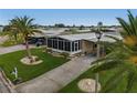 An aerial view shows a manufactured home with carport and a screened-in porch at 130 Nautical Dr, North Port, FL 34287