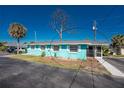 Charming turquoise home with white trim and a screened-in porch offers a cozy coastal feel at 470 S Mccall Rd # 10, Englewood, FL 34223