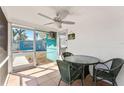 Inviting screened patio with ceiling fan and tile flooring, ideal for outdoor dining at 470 S Mccall Rd # 10, Englewood, FL 34223