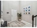 Bright foyer with high ceilings, modern decor, and tiled flooring at 7537 Pool Compass Loop, Wesley Chapel, FL 33545