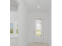 Bright and airy entryway with a white door and tiled floor at 9982 Beachwalk Dr, Englewood, FL 34223