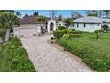 Single-Gathering home with a large yard and palm trees at 229 Rotonda E Blvd, Rotonda West, FL 33947