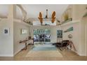 Bright and spacious living room with tiled floors and a large window at 229 Rotonda E Blvd, Rotonda West, FL 33947