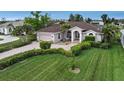 Single-Gathering house with a large yard and palm trees at 229 Rotonda E Blvd, Rotonda West, FL 33947