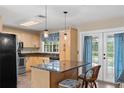 Kitchen with granite countertops, light wood cabinets, and stainless steel appliances at 18846 Ackerman Ave, Port Charlotte, FL 33948