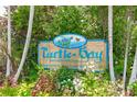 Turtle Bay community sign with contact information and rentals at 2375 N Beach Rd # 3B, Englewood, FL 34223