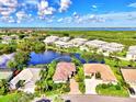 Aerial view of house and neighborhood by the lake at 3413 Pennyroyal Rd, Port Charlotte, FL 33953