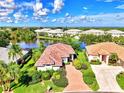 Aerial view of houses near a lake at 3413 Pennyroyal Rd, Port Charlotte, FL 33953