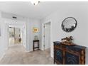 Bright entryway with tile flooring, decorative console table, and view to staircase at 11000 Placida Rd # 2303, Placida, FL 33946