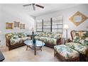Living room with rattan sofas and a coffee table at 8 Quails Run Blvd # 10, Englewood, FL 34223