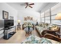Living room featuring rattan furniture and a ceiling fan at 8 Quails Run Blvd # 10, Englewood, FL 34223