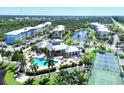 Aerial view of community pool, tennis courts and building at 8413 Placida Rd # 407, Placida, FL 33946