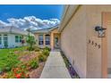 Front entrance with walkway and nicely landscaped flower beds at 3359 Osprey Ln, Port Charlotte, FL 33953