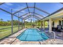 Relaxing screened-in pool area with patio furniture at 27 Broadmoor Ln, Rotonda West, FL 33947