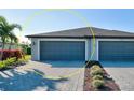 Two-car garage with paver driveway and landscaping at 2232 Bonito Way, Port Charlotte, FL 33953