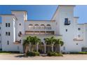 White building exterior with palm trees and entrance at 11100 Hacienda Del Mar Blvd # 202, Placida, FL 33946