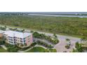 Aerial view of condo building near water at 8403 Placida Rd # 303, Placida, FL 33946