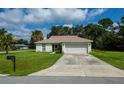 Single-story house with attached garage and driveway at 122 Swan Dr, Rotonda West, FL 33947