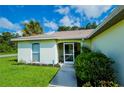 House exterior showcasing front entrance and walkway at 122 Swan Dr, Rotonda West, FL 33947