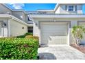 Townhome exterior featuring a garage and well-maintained landscaping at 3363 Grand Vista Ct # 203, Port Charlotte, FL 33953