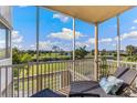 Enjoy beautiful water and golf course views from this condo's screened balcony with comfortable seating at 10055 Links Ln # 206, Rotonda West, FL 33947