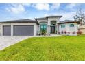 Stunning curb appeal with a three-car garage at 15424 Lakeland Cir, Port Charlotte, FL 33981