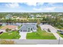 Property aerial view showcasing the home's canal-front location at 15424 Lakeland Cir, Port Charlotte, FL 33981